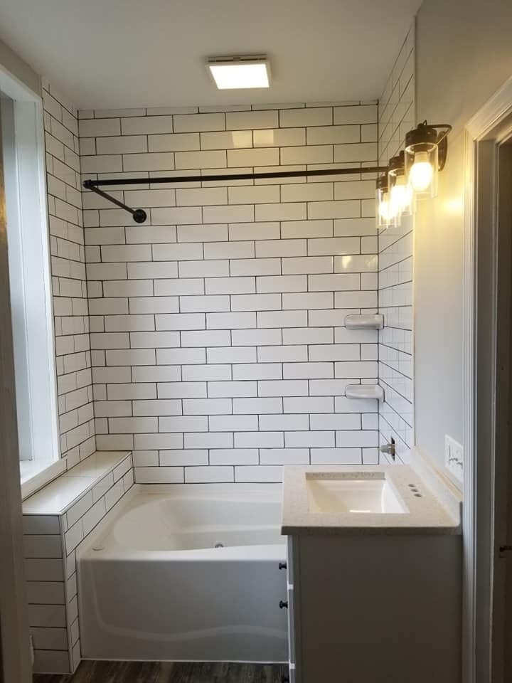 The same bathroom after the remodel, with subway tile and new vanity