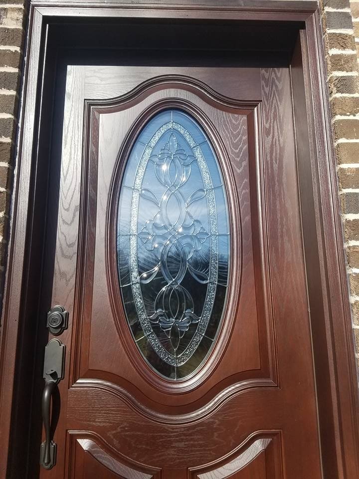 Entry door with an oval decorative glass insert