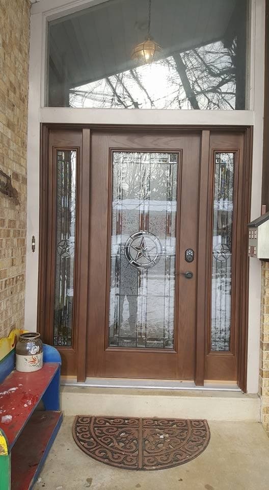 Close view of the decorative glass and brass hardware on a new entry door