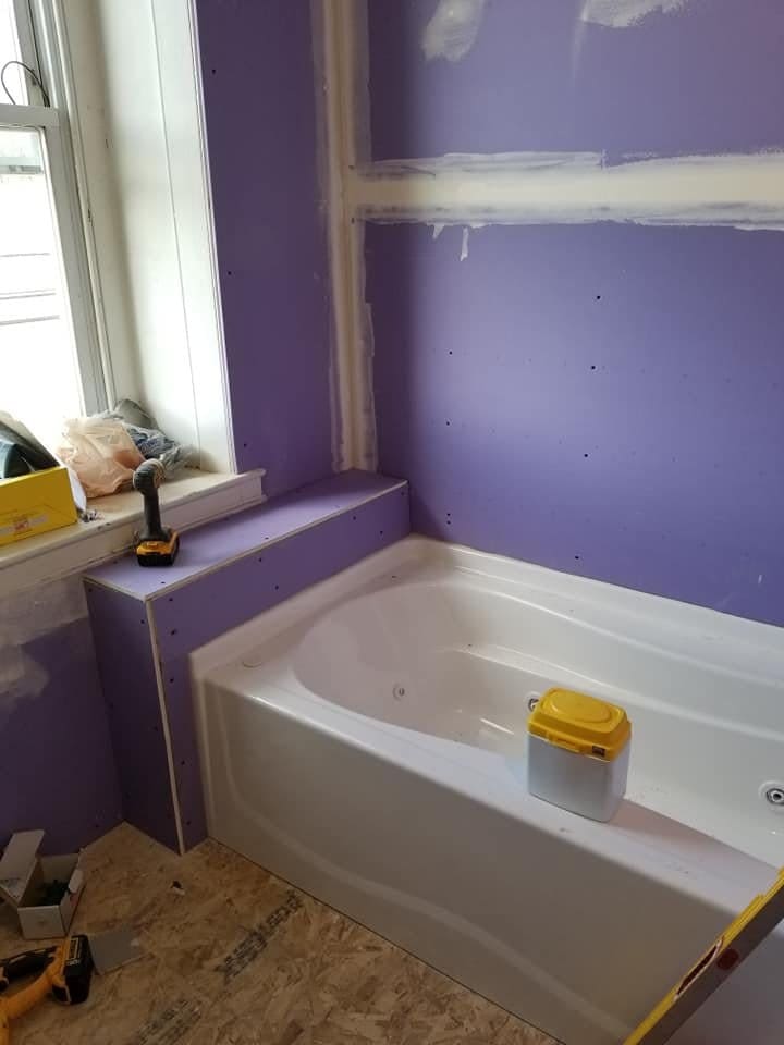 Jetted tub installed with cement board walls ready for tile