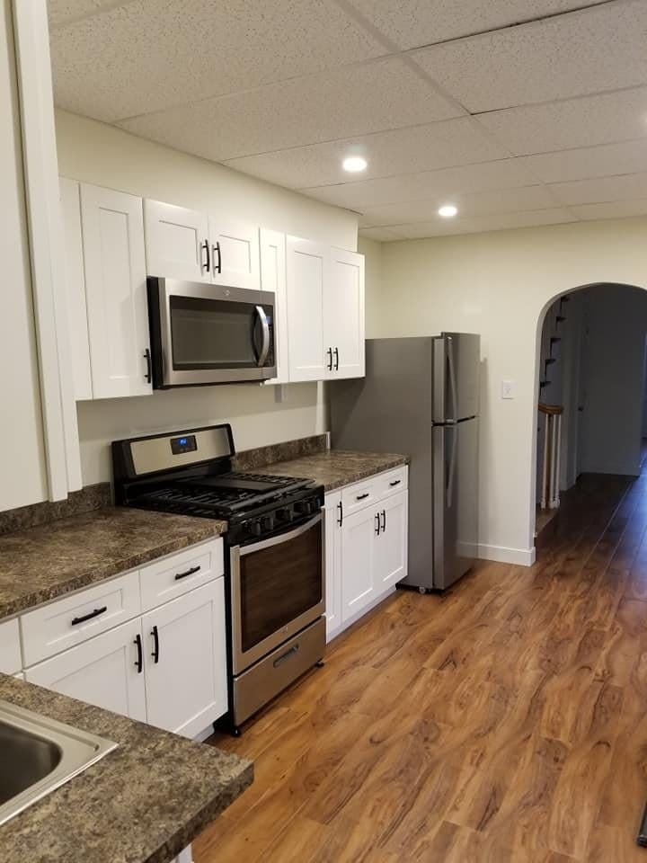 Remodeled kitchen with white shaker cabinets