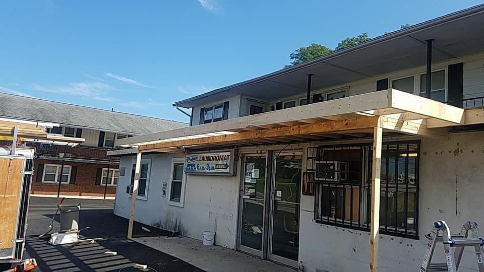 Porch roof framed along a storefront