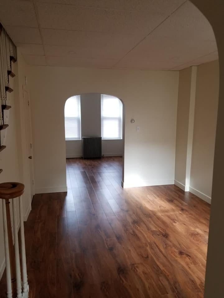 Living room with new flooring and fresh drywall