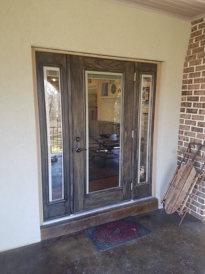 New sliding patio door installed in a brick wall