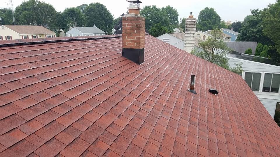 Brick chimney on a shingle roof with new step flashing