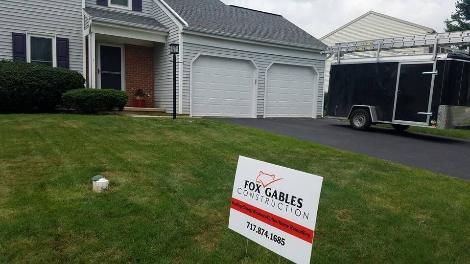 Home with new windows and a Fox Gables yard sign