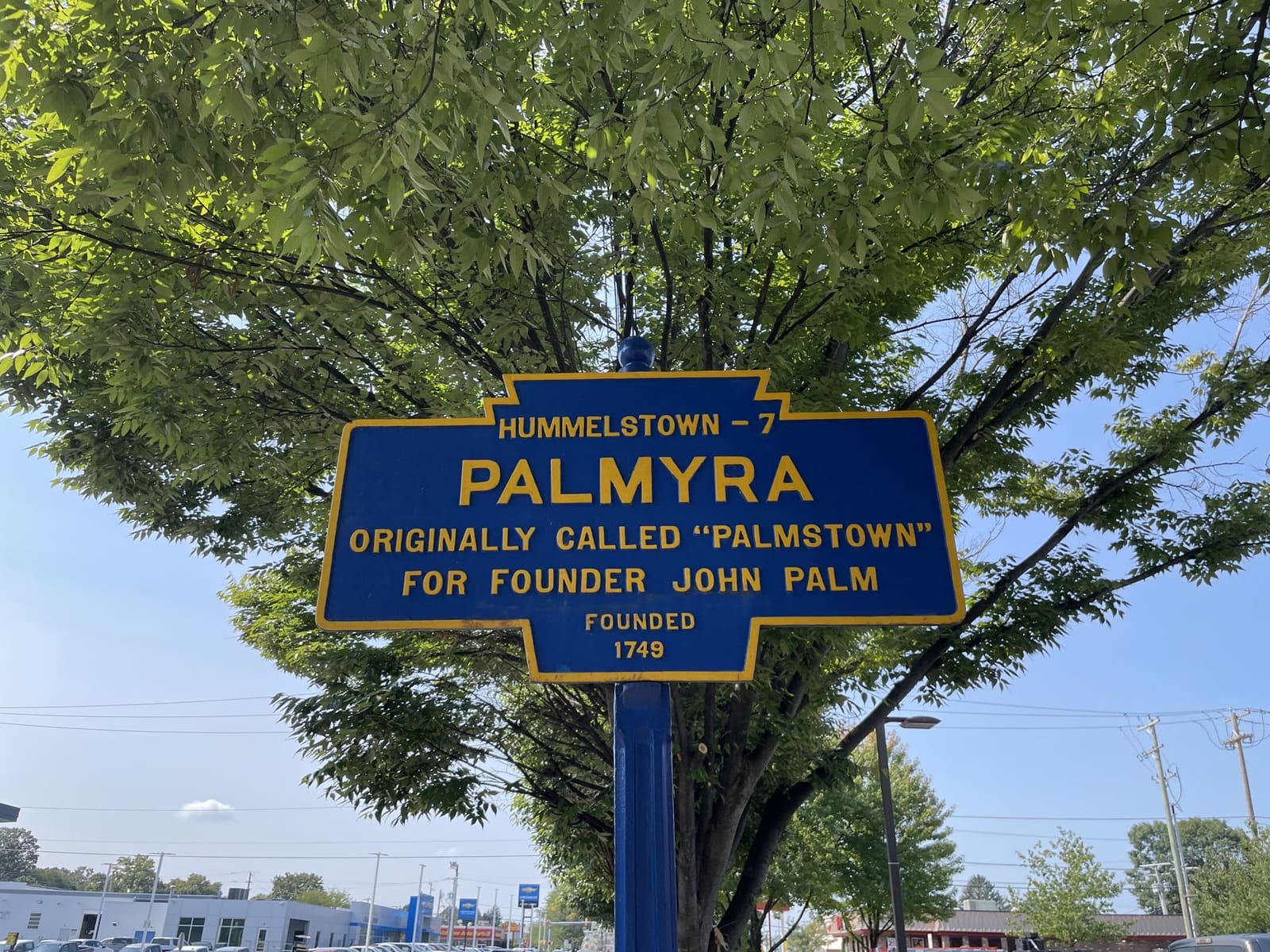 The blue Palmyra, Pennsylvania historical marker sign under a tree